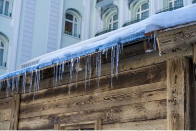 Snow on roof with icicles hanging down